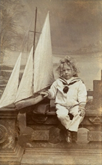 Little boy in his sailor suit with his toy boat Little boy in his sailor suit with his toy boat
