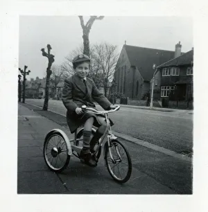 Little boy on a tricycle in a suburban street Little boy on a tricycle in a suburban street