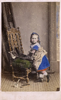 Little girl polishing her Fathers boots - studio portrait Little girl polishing her Fathers boots - studio portrait