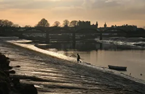 Lobster fisherman leaves boat and climbs bank of River Dee Lobster fisherman leaves boat and climbs bank of River Dee