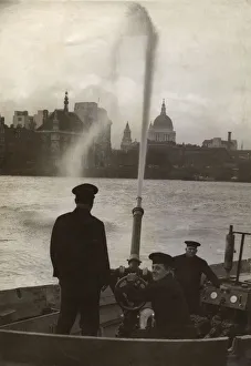London Fire Brigade firemen on a fireboat, River Thames London Fire Brigade firemen on a fireboat, River Thames