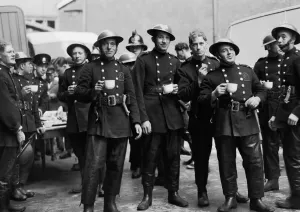 Prints of London firefighters (with cork helmets) and Auxiliary Fire Service firefighters (with tin hats and AFS badges on their tunics) Fire Brigade Prints: Firefighters on Tea Break at St Katherine Dock London Print
