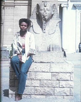 Lorna Holder sitting by a Sphinx-like statue - Egyptian Muse Lorna Holder sitting by a Sphinx-like statue - Egyptian Muse