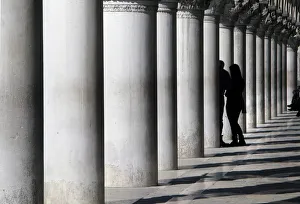 Lovers between marble pillars of the Doges Palace in Venice Lovers between marble pillars of the Doges Palace in Venice