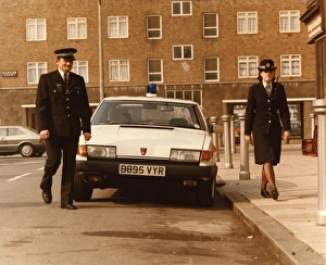 Male and female police officers in a London street Male and female police officers in a London street