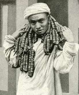 Man carrying coins round his neck, China, East Asia Man carrying coins round his neck, China, East Asia