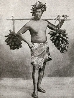 Man carrying fruit on a pole, Tahiti, French Polynesia Man carrying fruit on a pole, Tahiti, French Polynesia