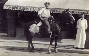Man on horseback outside a shop, USA Man on horseback outside a shop, USA