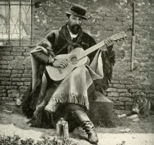 Man playing a guitar, Argentina, South America Man playing a guitar, Argentina, South America