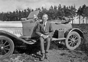 Man sitting on running board of sports car Man sitting on running board of sports car