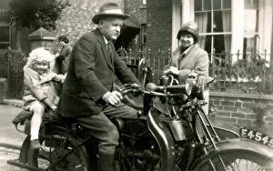 Man on veteran motorcycle with young girl Man on veteran motorcycle with young girl
