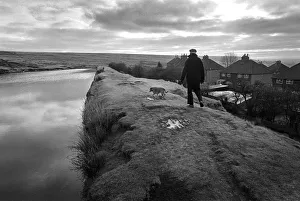 A man walks his dog along an embankment in Blaenavon, Wales A man walks his dog along an embankment in Blaenavon, Wales