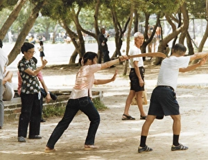 Man and woman shadow boxing in the park in Hong Kong Man and woman shadow boxing in the park in Hong Kong