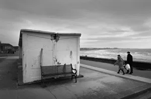 Man and woman walk along the sea front in high winds, Troon Man and woman walk along the sea front in high winds, Troon