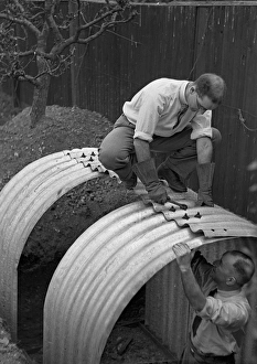 Two men constructing an Anderson shelter Two men constructing an Anderson shelter