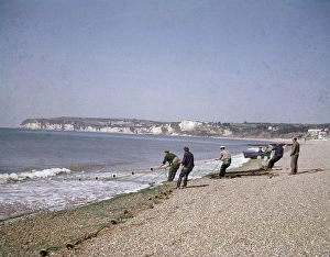 Men with fishing nets at Seaton, Devon Men with fishing nets at Seaton, Devon