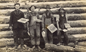 Four men with trowels and cement on boards, USA Four men with trowels and cement on boards, USA