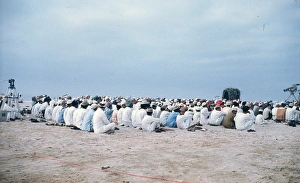 Men and young boys sitting on the beach in Oman Men and young boys sitting on the beach in Oman