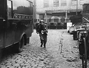 A messenger runs with the news that a gas main is on fire after an air raid during World A messenger runs with the news that a gas main is on fire after an air raid during World