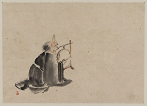 A monk wearing a mask(?) with a horn, sitting on the ground A monk wearing a mask(?) with a horn, sitting on the ground