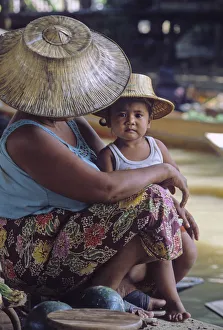 Mother and child wearing traditional Thai hats, or ngobs Mother and child wearing traditional Thai hats, or ngobs