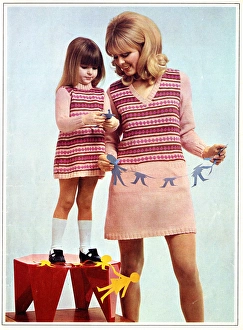 Mother and daughter in matching knitted outfits Mother and daughter in matching knitted outfits