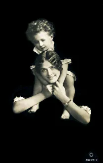 Mother with her young son carried on her shoulders Mother with her young son carried on her shoulders