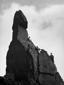 Prints of Rock climbers larking about on Napes Needle, Great Gable, Lake District, Cumbria, England. Date: 1950s Lake Prints: Napes Needle Rock Climbers Print, 1950s