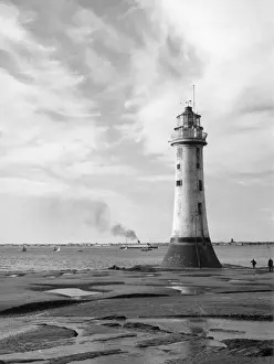 Prints of Low tide at New Brighton, Cheshire, England, showing its fine lighthouse. The Isle of Man steamer is in the distance. Date: 1960s Chepstow Prints: New Brighton Lighthouse Low Tide Print, 1960s