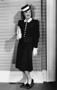 Prints of A black wool suit designed by Dolly Tree was worn by Rita Johnson in The Golden Fleecing (1940), The skirt was fitted at the hips, flared at the hem, and worn with a dressmaker jacket Rita Prints: A Black Wool Suit Designed by Dolly Tree, 1940 Print