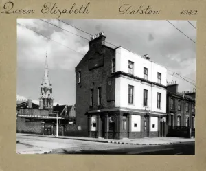 Prints of Photograph of Queen Elizabeth PH, Dalston, London. The main side of the print (shown here) depicts: Corner on view of the pub Royalty Prints: Queen Elizabeth PH, Dalston London Print 1942