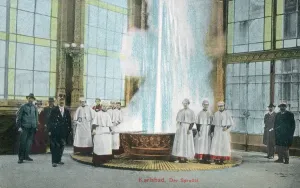 Prints of Karlovy Vary or Carlsbad (Karlsbad), in western Bohemia, Czech Republic - The Sprudel (Mineral Hot Water Spring Fountain or Geyser) and Spa Attendants in their waterproof uniforms! Date: circa 1911 Czech Republic Prints: Karlovy Vary Print: Sprudel and Spa Attendants, circa 1911
