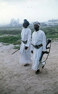 Omani elders wearing Khanjar and carrying rifles in Oman Omani elders wearing Khanjar and carrying rifles in Oman