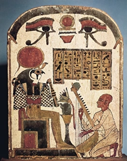 Painted wood stele depicting Amon musician playing Painted wood stele depicting Amon musician playing