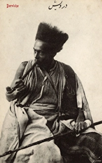 Pipe-smoking Syrian Dervish with fantastic hairstyle Pipe-smoking Syrian Dervish with fantastic hairstyle