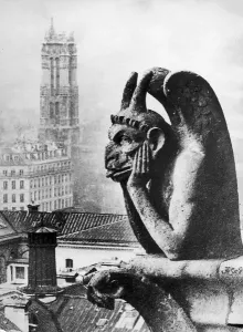 Prints of Black Peter the stone gargoyle of Notre Dame is 250ft above the ground. All Parisienne children know he watches out for naughty children France Prints: Paris Gargoyle Black Peter Print: A 250ft stone guardian of Notre Dame