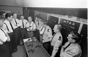 Prints of Inspector Robert Gould gives instruction to a group of trainees at the police underground shooting range in North London. Date: 1960s Police Prints: Police Gun School, North London Print 1960s