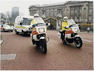 Prints of Metropolitan Police motorcyclists esccorting an ambulance past Buckingham Palace in London Police Prints: Metropolitan Police Motorcyclists Escorting an Ambulance Print