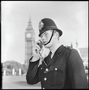 Prints of Police officer on walkie talkie in London. Metropolitan Police Police Prints: London Metropolitan Police Officer Print