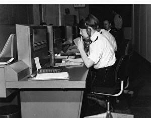 Police officers at work in communications room Police officers at work in communications room