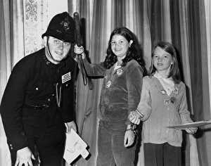 Policeman in 1920s uniform, with two girls Policeman in 1920s uniform, with two girls