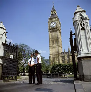 Policemen guarding Palace of Westminster with Big Ben Policemen guarding Palace of Westminster with Big Ben