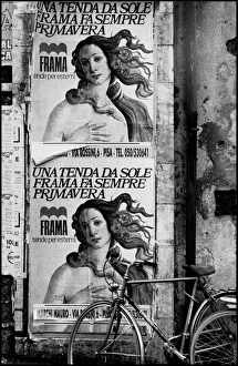 Posters on wall with bicycle, Pisa, Italy Posters on wall with bicycle, Pisa, Italy