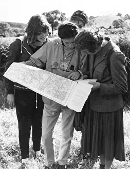 Prints of Which way? Ramblers study a map on the Clent Hills, Worcestershire, England. Date: early 1960s Worcestershire Prints: RAMBLERS, 1960S Print - Clent Hills, Worcestershire