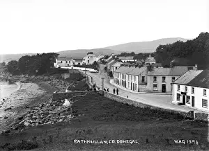 Prints of Rathmullan, Co. Donegal - an elevated view of the village with a group of men standing by the sea wall. (Location: Republic of Ireland: County Donegal: Rathmullan). Date: circa early 1900s Republic Of Ireland Prints: Rathmullan, Co. Donegal Print - Early 20th Century