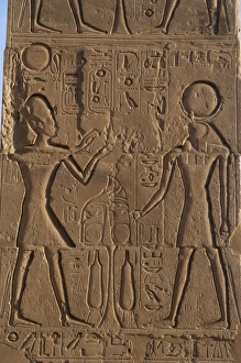 Relief depicting a Pharaoh making offerings to the god Ra. R Relief depicting a Pharaoh making offerings to the god Ra. R
