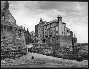 Prints of A boy runs ahead of his grandparents to the beach at Robin Hoods Bay, North Yorkshire, a charming old town from whence, legend has it, Robin Hood escaped by sea North Yorkshire Prints: Robin Hoods Bay Print: A Boy Runs Ahead to the Beach