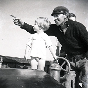 Sailor and small child at the ships wheel Sailor and small child at the ships wheel