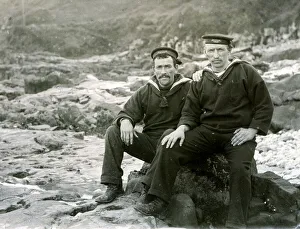 Two sailors sitting on coastal rocks Two sailors sitting on coastal rocks