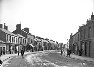 Prints of Sandy Row, Belfast - a street scene with shop fronts and a lot of people on a curving road. (Location: Northern Ireland: County Antrim: Belfast). Date: circa early 1900s County Antrim Prints: Early 20th Century Print of Sandy Row, Belfast